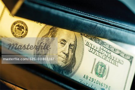 Close-up of one hundred dollar bill inside wallet