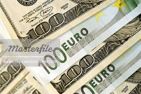 Euro 100 bank notes and United States one hundred dollar bills, close-up