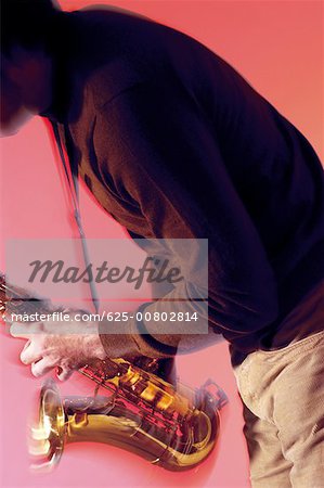 Mid section view of a musician playing the saxophone