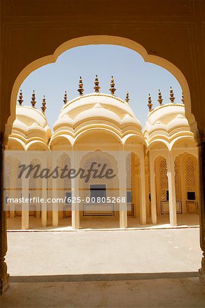 Facade of a palace seen through an arched corridor, City Palace, Jaipur, Rajasthan, India