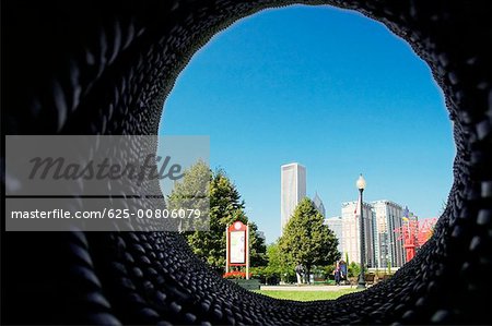 Skyscrapers viewed through a hole in a wall, Gateway Park, Chicago, Illinois, USA