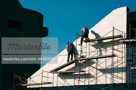 Workers instaling panel for Wostwood building 1