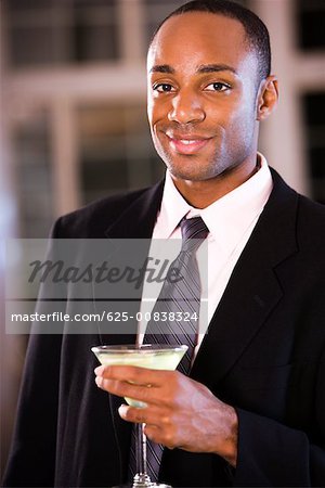 Portrait of a businessman holding a martini glass