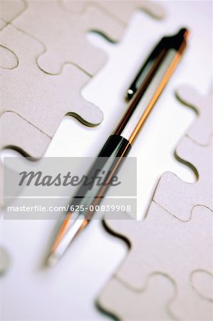 Close-up of a pen with a jigsaw puzzle