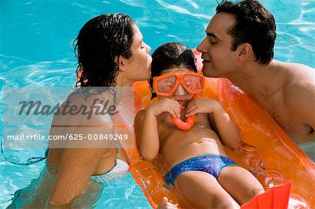 High angle view of parents with their daughter in a swimming pool
