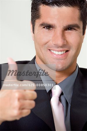 Portrait of a businessman showing thumbs up