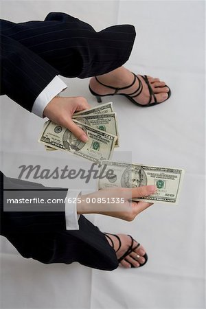 High angle view of a woman holding American dollar bills