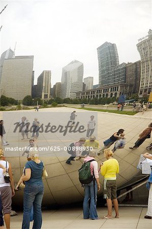 Reflection of a group of people standing in front of buildings, Chicago, Illinois, USA