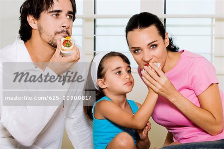 Close-up of a young man eating a pastry