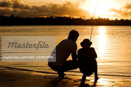 Fishing Sunset Father and Son Fishing Silhouette Stock Image