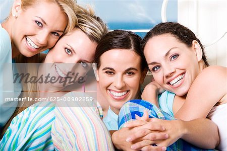 Portrait of four young women smiling