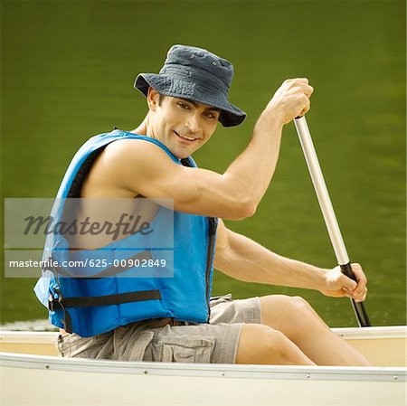 Portrait of a mid adult man boating in a river