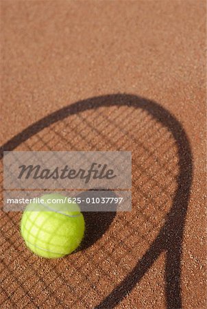 Close-up of a tennis ball on the shadow of a tennis racket