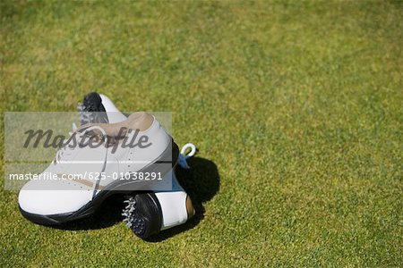 Close-up of a pair of golf shoes on the grass