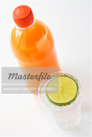 High angle view of a bottle of juice with a glass of lemonade