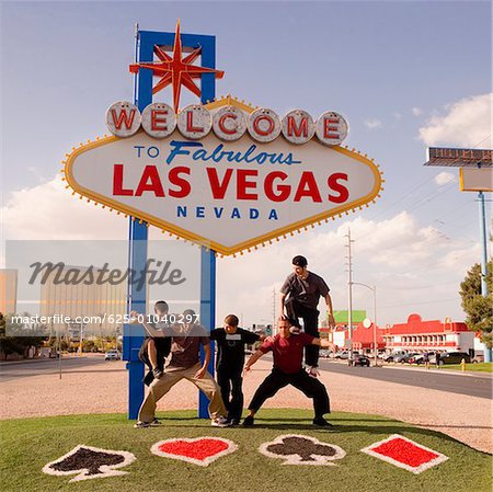 Five teenage boys posing in front of a Las Vegas sign board, Las Vegas, Nevada, USA