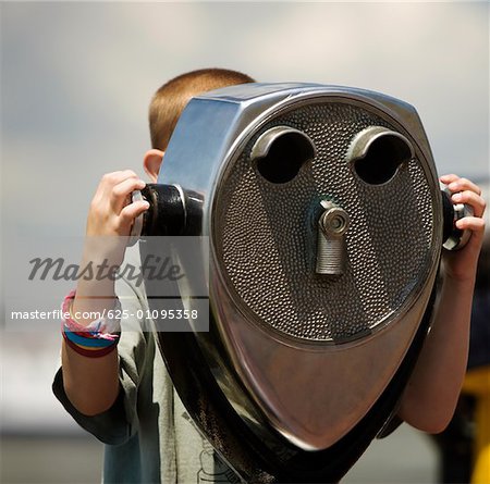 Close-up of a person looking through coin-operated binoculars, New York City, New York State, USA