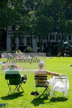 Group of people sunbathing in a park