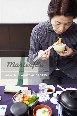 High angle view of a senior woman eating
