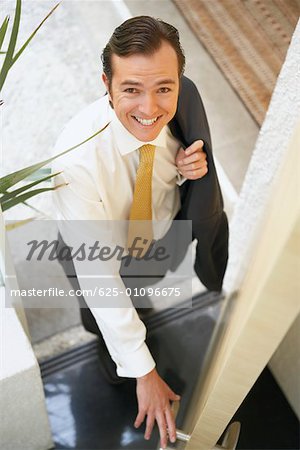 High angle view of a businessman opening a door
