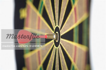 Dart in the bull's-eye of a dartboard