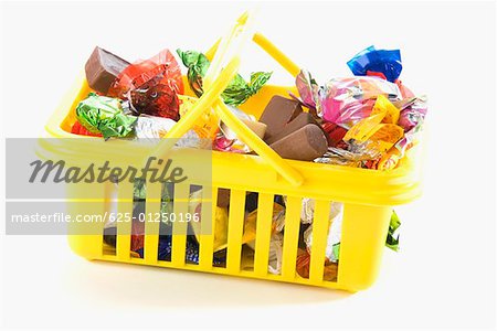 Close-up of chocolates and gifts in a basket