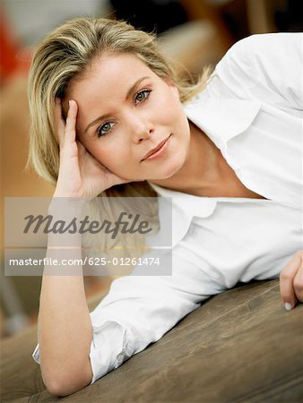 Portrait of a mid adult woman lying on the bed and thinking