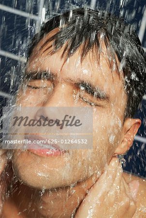 Close-up of a young man in the shower