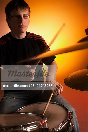 Male drummer playing drums