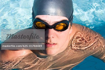 Portrait of a young man in a swimming pool