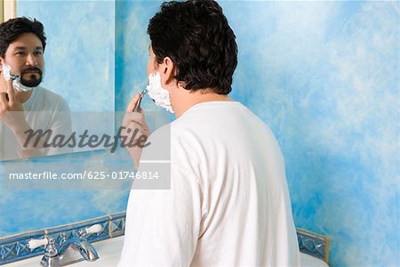 Mid adult man shaving in the bathroom