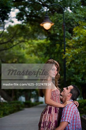 Side profile of a young couple romancing