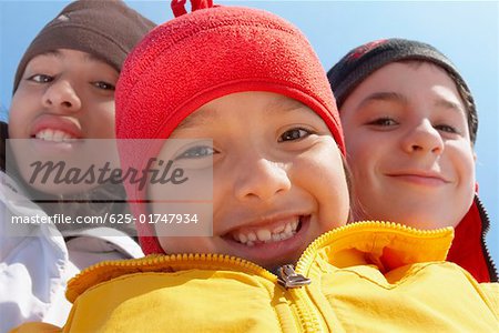 Portrait of a boy smiling with his two friends