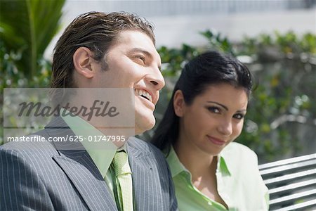 Close-up of a businessman smiling with a businesswoman