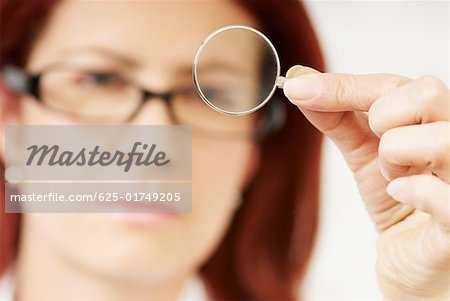Close-up of a female optometrist holding a lens