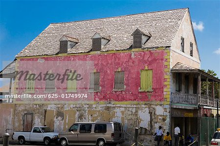 Two vehicles parked beside a house, Bay Street, Nassau, Bahamas