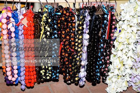 Close-up of garlands and necklaces hanging in a store