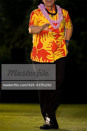 Man hula dancing in a lawn, Waikiki Beach, Honolulu, Oahu, Hawaii Islands, USA
