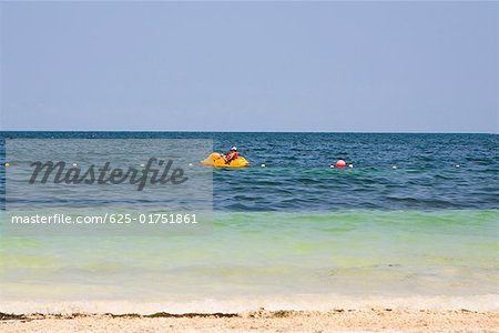 Side profile of a person boating in the sea, Cancun, Mexico