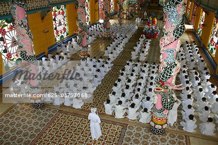 High angle view of a group of people praying in a monastery, Cao Dai Monastery, Tay Ninh, Vietnam