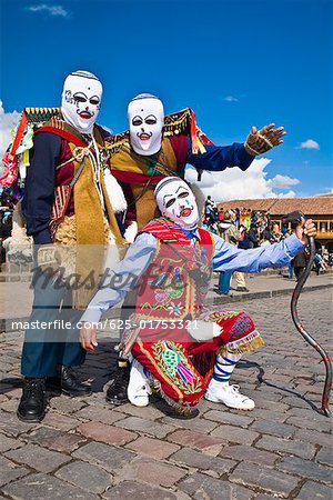 Three people wearing traditional costumes in a festival, Peru