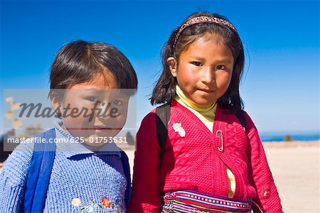 Portrait of a girl with a boy, Taquile Island, Lake Titicaca, Puno, Peru