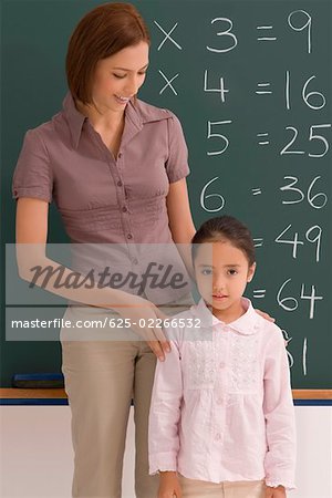 Female teacher with her student in a classroom