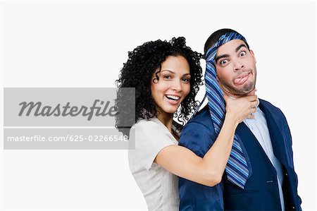 Portrait of a businesswoman pretending to strangulate a businessman