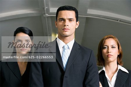 Businessman standing with two businesswomen in a subway