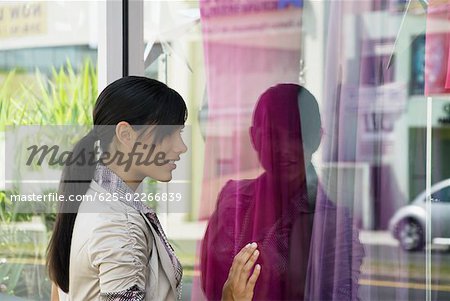 Side profile of a young woman window shopping