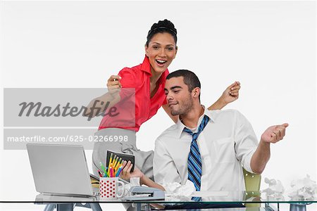 Businesswoman and a businessman dancing together in an office