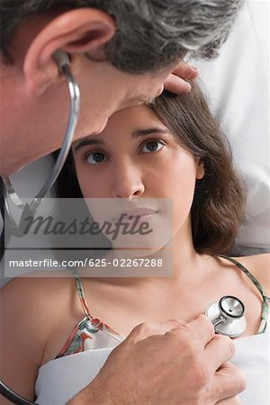 High angle view of a male doctor examining a young woman