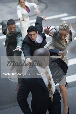 High angle view of business executives chasing a businessman