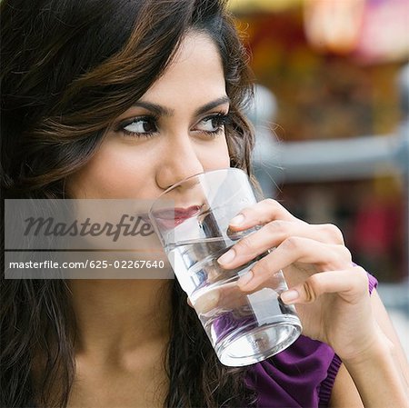Close-up of a young woman drinking water